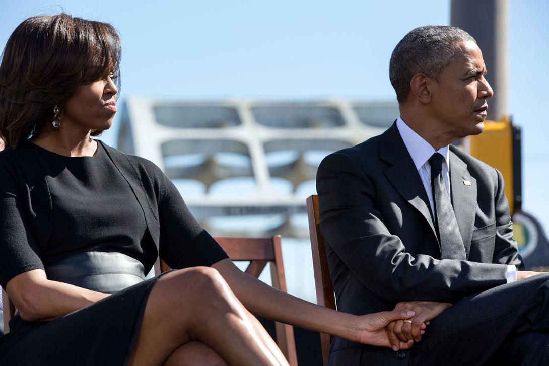 President Barack Obama and First Lady Michelle Obama hold hands at the 2015 Selma anniversary commemoration